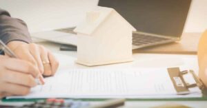 A man signing a liability insurance claim