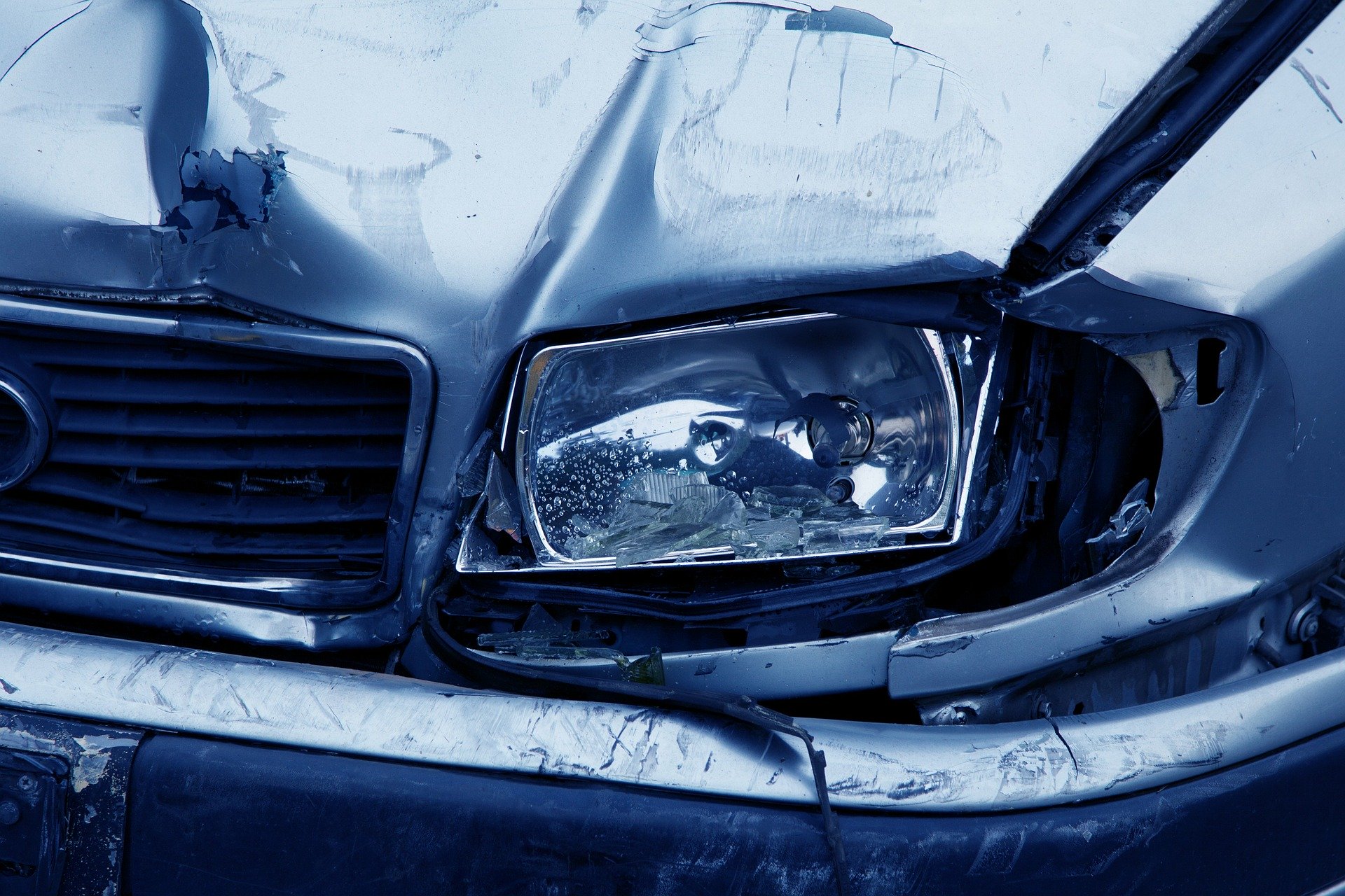 A blue car wrecked from a car accident