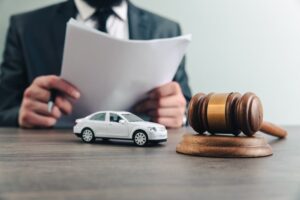 Judge with a toy car and gavel on the table.