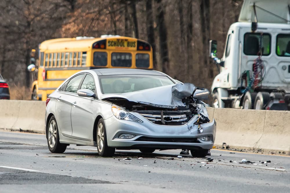 Dangerous intersection Car crash accident on a highway during the day with no traffic around.