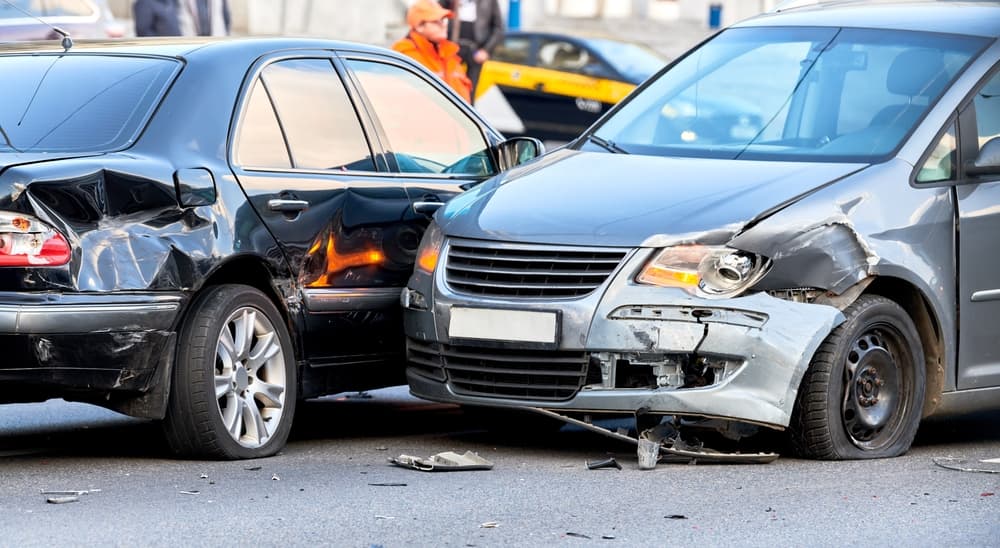 Car crash accident on the street with damaged vehicles.