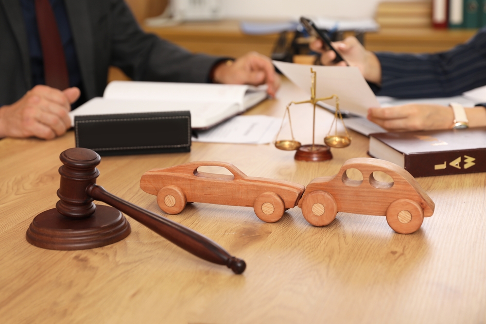 Wooden cars with judge's gavel on lawyer's table