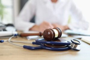 Judge gavel, stethoscope doctor in background in a personal injury case