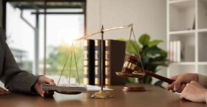 Scales of justice with gavel and money symbolizing legal settlement, bribery, or financial compensation in a law office