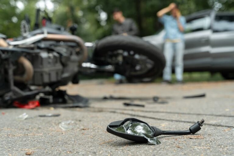 Motorcycle accident scene in Kentucky showing a damaged bike and debris on the road, highlighting the urgent steps victims should take afterward.